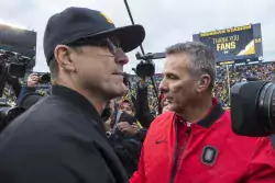 Jim Harbaugh will try and beat Urban Meyer for the first time this Saturday