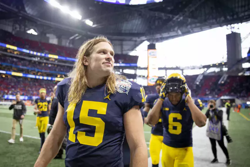 Chase Winovich walks off the field after the Chik-fil-A Peach Bowl
